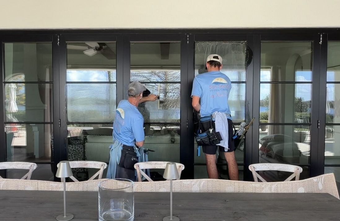 Sun Sands technician cleaning a window in Windermere, FL