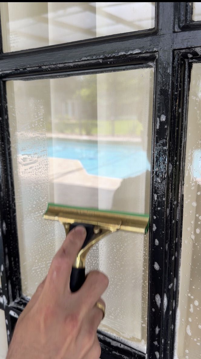 Sun Sands technician cleaning a window in Windermere, FL